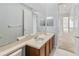 Double vanity bathroom with a large mirror and access to hallway at 2620 Sand Arbor Cir, Orlando, FL 32824