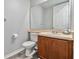 Simple bathroom with wooden vanity, toilet, and mirror at 2620 Sand Arbor Cir, Orlando, FL 32824