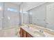 Bathroom boasts double vanity, tub, and large mirror at 2620 Sand Arbor Cir, Orlando, FL 32824