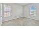 Bedroom with two windows, neutral walls, and carpeted floor at 2620 Sand Arbor Cir, Orlando, FL 32824