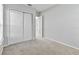 Spacious bedroom with neutral walls and carpet, featuring a double door closet and window at 2620 Sand Arbor Cir, Orlando, FL 32824