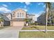 Two-story house with stone accents and a two-car garage at 2620 Sand Arbor Cir, Orlando, FL 32824