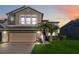 Two-story house with stone accents and a two-car garage at 2620 Sand Arbor Cir, Orlando, FL 32824