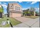 Two-story house with stone accents and a two-car garage at 2620 Sand Arbor Cir, Orlando, FL 32824