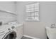 Laundry room with washer, dryer, and utility sink at 2620 Sand Arbor Cir, Orlando, FL 32824