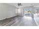 Bright living room with lake view, vinyl flooring, and sliding glass doors at 2620 Sand Arbor Cir, Orlando, FL 32824