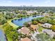 Aerial view of two houses near a lake, with a city skyline in the background at 2682 Orange Peel Ct, Orlando, FL 32806