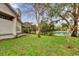 Backyard with green grass and pond view, offering serenity at 2682 Orange Peel Ct, Orlando, FL 32806