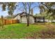 Landscaped backyard with wooden fence, providing privacy at 2682 Orange Peel Ct, Orlando, FL 32806
