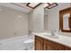 Clean bathroom with neutral tile, wood vanity, and a large mirror at 2682 Orange Peel Ct, Orlando, FL 32806
