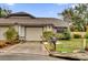 Tan house with brown roof, attached garage, and landscaping at 2682 Orange Peel Ct, Orlando, FL 32806
