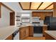 Kitchen with wood cabinets, white countertops, and black appliances at 2682 Orange Peel Ct, Orlando, FL 32806