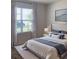 Cozy bedroom with a large window, comfortable bed with decorative pillows, and stylish decor at 2723 Sunkissed Dr, St Cloud, FL 34771