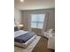 Serene bedroom with neutral colors, plush carpet, a comfortable bed with stylish linens, and a side chair at 2723 Sunkissed Dr, St Cloud, FL 34771