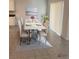 Inviting dining room featuring a modern white table with seating for six, bright sunlight, and contemporary decor at 2723 Sunkissed Dr, St Cloud, FL 34771