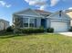 Charming single-Gathering home featuring a well-manicured lawn and an attached two-car garage in a suburban neighborhood at 2723 Sunkissed Dr, St Cloud, FL 34771