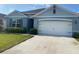 Beautiful single-story home featuring a two-car garage, manicured lawn, and a welcoming entrance at 2723 Sunkissed Dr, St Cloud, FL 34771