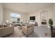 Bright living room with neutral tones, modern furniture, large window, and a view to the backyard at 2723 Sunkissed Dr, St Cloud, FL 34771