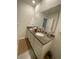 Bathroom featuring a double sink vanity with granite counters, large mirror, and white cabinets at 2723 Sunkissed Dr, St Cloud, FL 34771