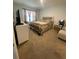 Comfortable bedroom with carpet flooring and neutral decor, featuring a queen-sized bed at 2723 Sunkissed Dr, St Cloud, FL 34771