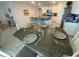 Elegant dining area with a wooden table set for a meal, adjacent to a modern kitchen at 2723 Sunkissed Dr, St Cloud, FL 34771