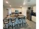 Kitchen island with granite countertop, stylish barstools, and modern appliances at 2723 Sunkissed Dr, St Cloud, FL 34771