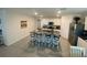 Kitchen island with granite countertop, stylish barstools, and modern appliances at 2723 Sunkissed Dr, St Cloud, FL 34771