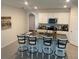 Kitchen island with granite countertop, stylish barstools, and modern appliances at 2723 Sunkissed Dr, St Cloud, FL 34771