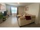 Bright living room featuring tile floors, large window, and comfortable seating with throw pillows at 2723 Sunkissed Dr, St Cloud, FL 34771