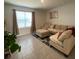 Bright living room featuring tile floors, large window, and comfortable seating with throw pillows at 2723 Sunkissed Dr, St Cloud, FL 34771
