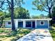 Newly renovated ranch home featuring a blue exterior and a long driveway at 308 Hope Cir, Orlando, FL 32811