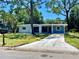 Ranch style home with blue exterior, driveway, and landscaped lawn at 308 Hope Cir, Orlando, FL 32811