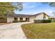 Single story home with curved driveway and manicured lawn at 1116 Fairway Dr, Winter Park, FL 32792