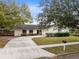 House with a driveway and mature trees in the front yard at 1116 Fairway Dr, Winter Park, FL 32792