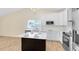 Updated kitchen with white cabinets and a center island at 1116 Fairway Dr, Winter Park, FL 32792