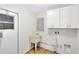 Clean laundry room with upper cabinets and utility sink at 1116 Fairway Dr, Winter Park, FL 32792
