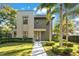 Modern two-story home with landscaped lawn and palm trees at 1970 Laurel Rd, Winter Park, FL 32789