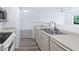 Bright kitchen with stainless steel sink, laminate countertops, and ample cabinet space, transitioning to the living area at 3032 Parkway Blvd # 302, Kissimmee, FL 34747