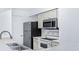Functional kitchen with stainless steel refrigerator, and electric range, and white cabinetry offering ample storage at 3032 Parkway Blvd # 302, Kissimmee, FL 34747