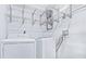 Functional laundry area with washer, dryer, and metal shelving for organization, maximizing space efficiency at 3032 Parkway Blvd # 302, Kissimmee, FL 34747