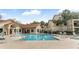 Community pool with ample seating and well-maintained landscaping at 3032 Parkway Blvd # 302, Kissimmee, FL 34747