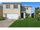 Two-story house with a two-car garage and well-maintained lawn at 3282 Eastgrove Ter, Sanford, FL 32771