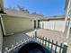 A backyard featuring a paved patio, complemented by a green exterior wall and white trim at 7128 Five Oaks Dr, Harmony, FL 34773