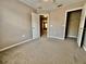 Bedroom with neutral carpet, closet, and doorway to other rooms at 7128 Five Oaks Dr, Harmony, FL 34773