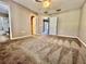 Spacious bedroom featuring a ceiling fan, neutral walls, and multiple entryways adding to the room's layout and functionality at 7128 Five Oaks Dr, Harmony, FL 34773