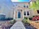 Two-story home featuring a tidy front yard with a welcoming entrance at 7128 Five Oaks Dr, Harmony, FL 34773