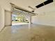 An empty garage with an open door provides ample space for parking and storage at 7128 Five Oaks Dr, Harmony, FL 34773