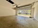 A garage with open door showing the exterior of the house and a vehicle parked in front at 7128 Five Oaks Dr, Harmony, FL 34773