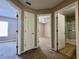 Hallway with multiple doors leading to bedrooms and a bathroom providing convenient access to different areas of the home at 7128 Five Oaks Dr, Harmony, FL 34773