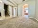 Spacious living room with staircase, neutral paint, and adjacent kitchen view at 7128 Five Oaks Dr, Harmony, FL 34773